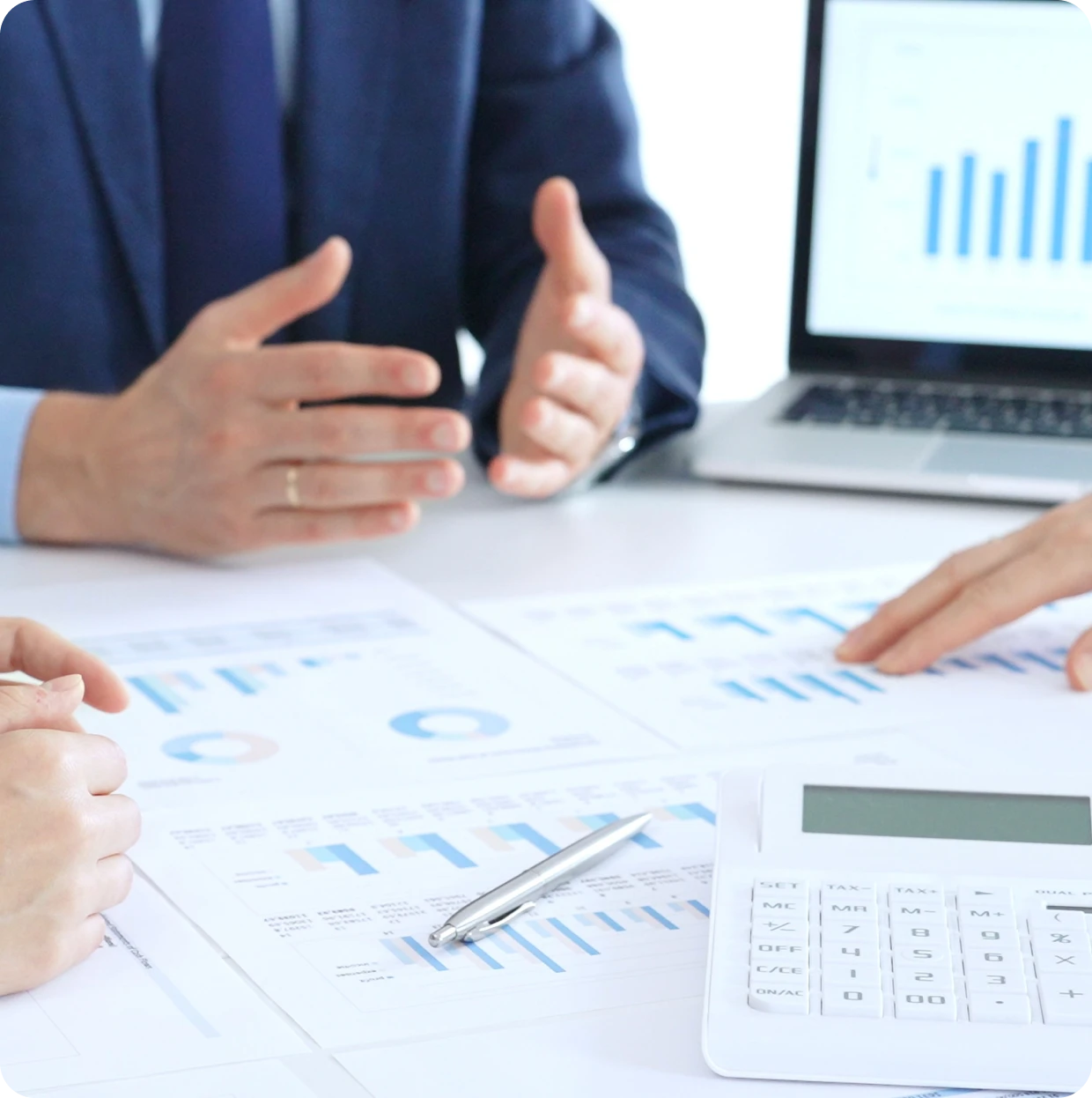 Executives discussing financial reports at table